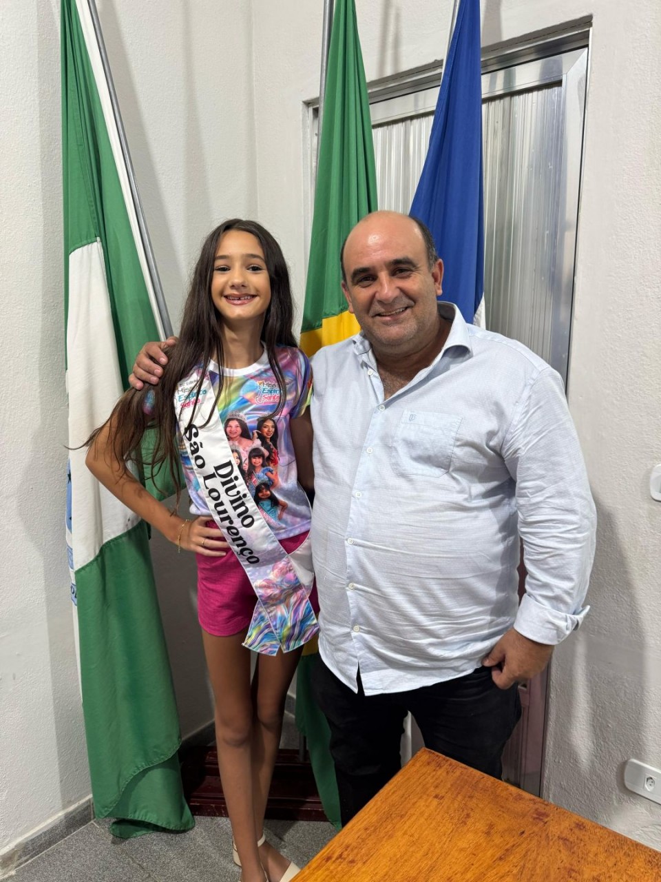 Ayla usando faixa do município de Divino de São Lourenço ao lado do prefeito municipal, Dudu Queiroz.