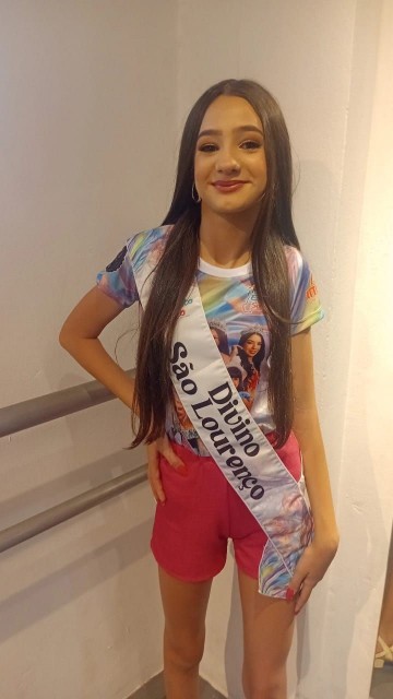 Ayla usa faixa com o nome do município Divino de São Lourenço.