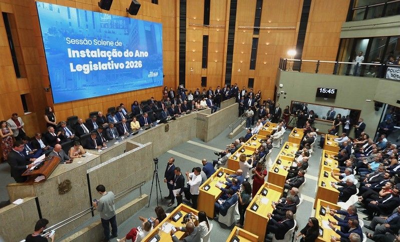 Vista panorâmica do Plenário Dirceu Cardoso que está lotado de deputados e autoridades, durante a Sessão Solene de Instalação do Ano Legislativo 2026, com o painel eletrônico azul ao fundo exibindo o título do evento.
