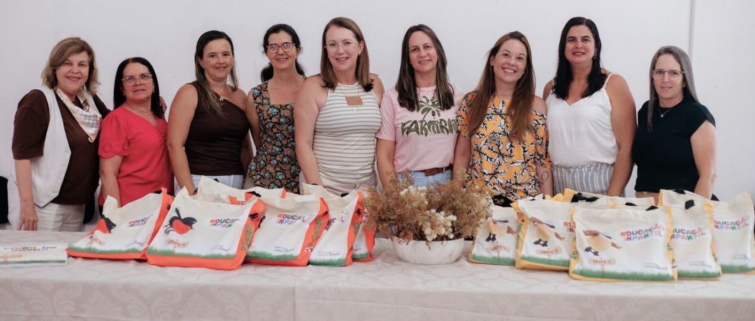 Equipe da Educação Infantil de Irupi posa para foto durante formação do Sistema Aprende Brasil, com materiais didáticos destinados a alunos de 4 e 5 anos.